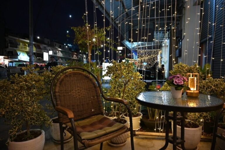 Outdoor patio seating with string lights at night