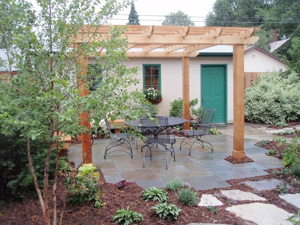 Wooden pergola over a stone patio