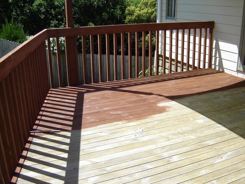 Wooden deck being stained, half finished