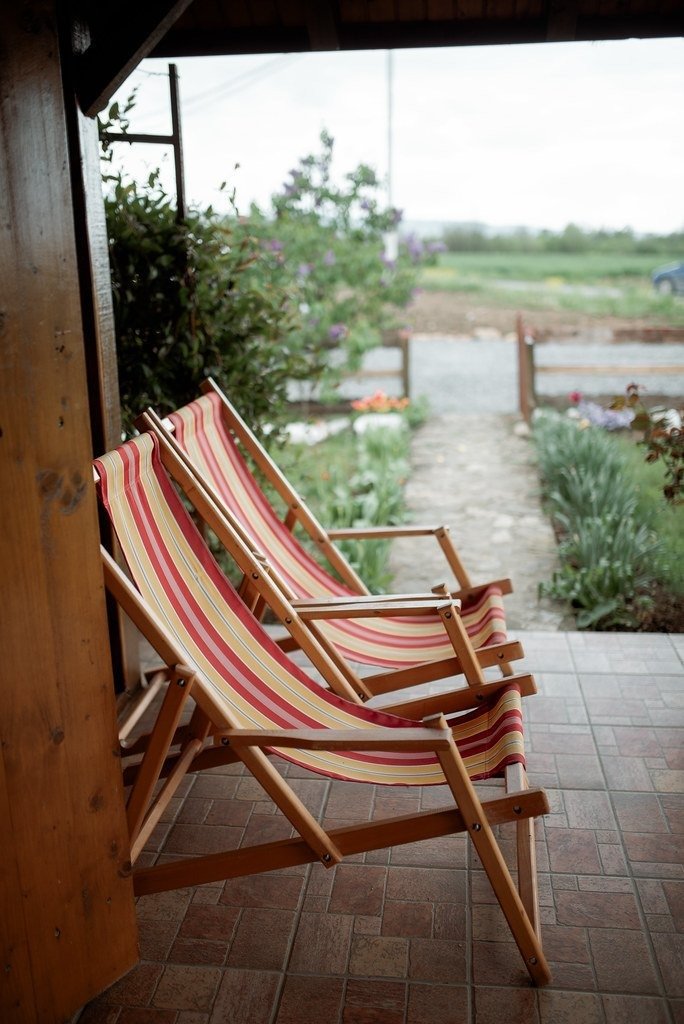 Striped chairs on a small covered deck